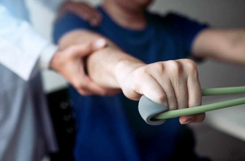 Person exercising with elastic resistance bands.