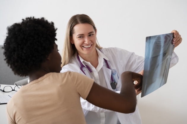 doctor showing x ray result to a patient