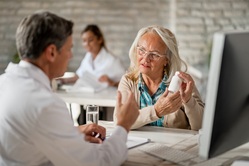 Doctor giving medication instructions to a woman.