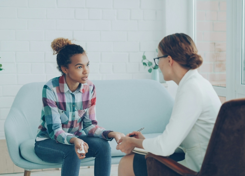 Doctor speaking with a young girl.