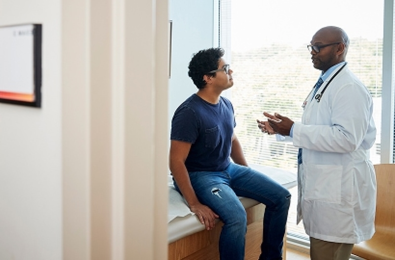 Doctor speaking with a young man.
