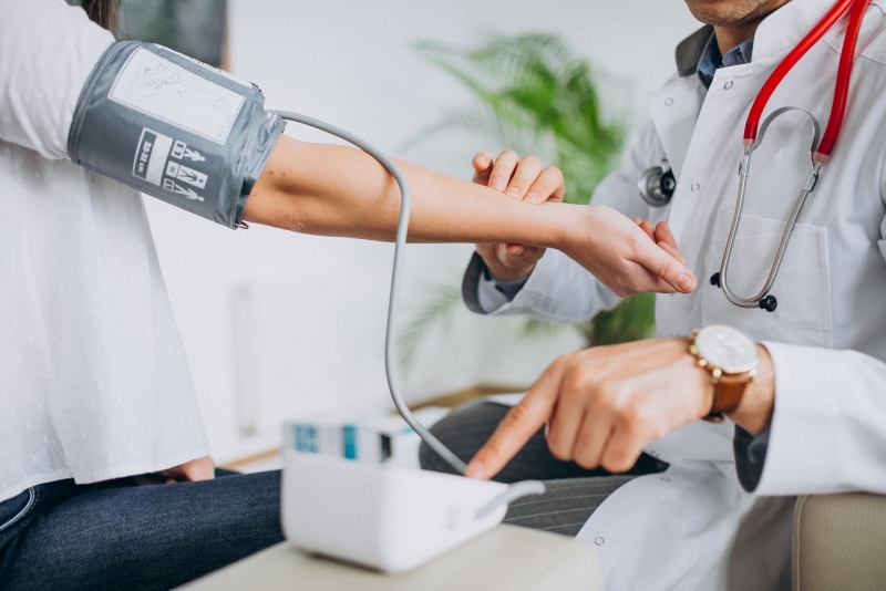 Doctor checking a patient’s blood pressure.